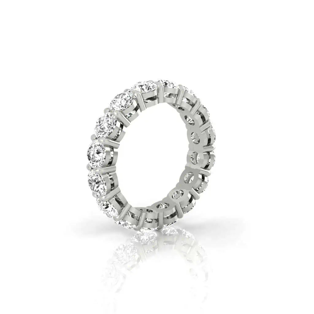 The Full Diamond Eternity Ring from Janet Heller Fine Jewelry, crafted in 18KT gold, features evenly spaced diamonds offered in various shapes and custom carat weights. The color of the diamonds is F and the clarity is VS. This is the perfect wedding band to be worn alone or stacked with your engagement ring.