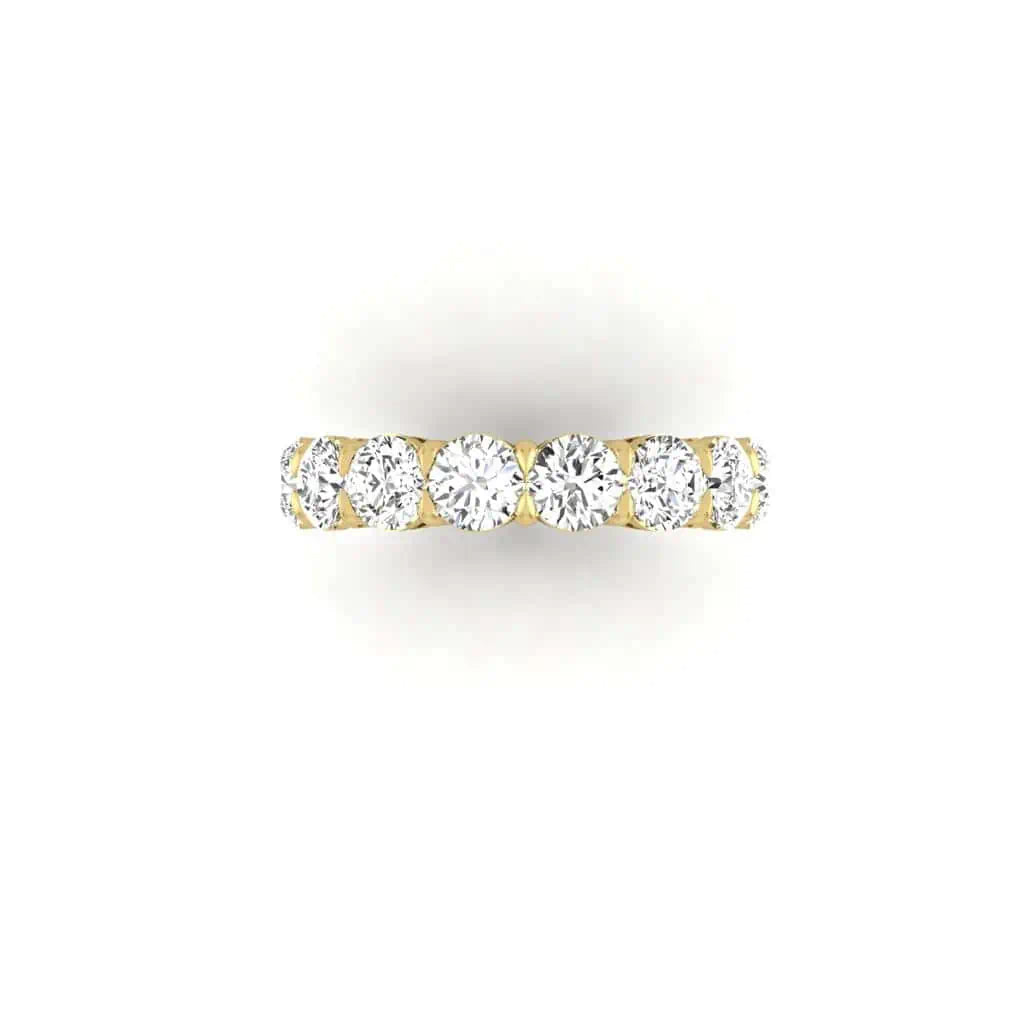 The Full Diamond Eternity Ring from Janet Heller Fine Jewelry, crafted in 18KT gold, features evenly spaced diamonds offered in various shapes and custom carat weights. The color of the diamonds is F and the clarity is VS. This is the perfect wedding band to be worn alone or stacked with your engagement ring.