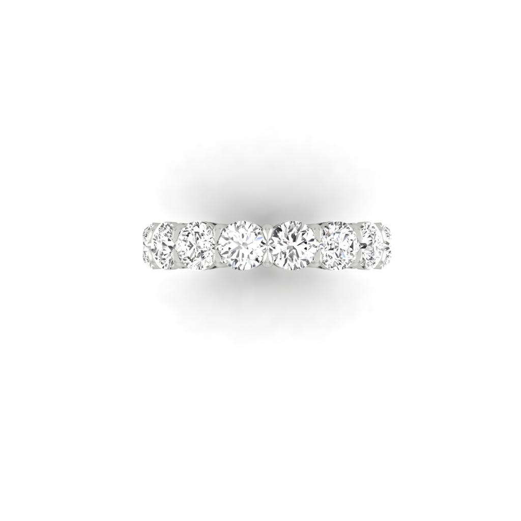 The Full Lab Grown Diamond Eternity Ring is an 18KT gold band featuring seven F Color VS Clarity diamonds, evenly spaced to enhance their brilliance against a plain white background.