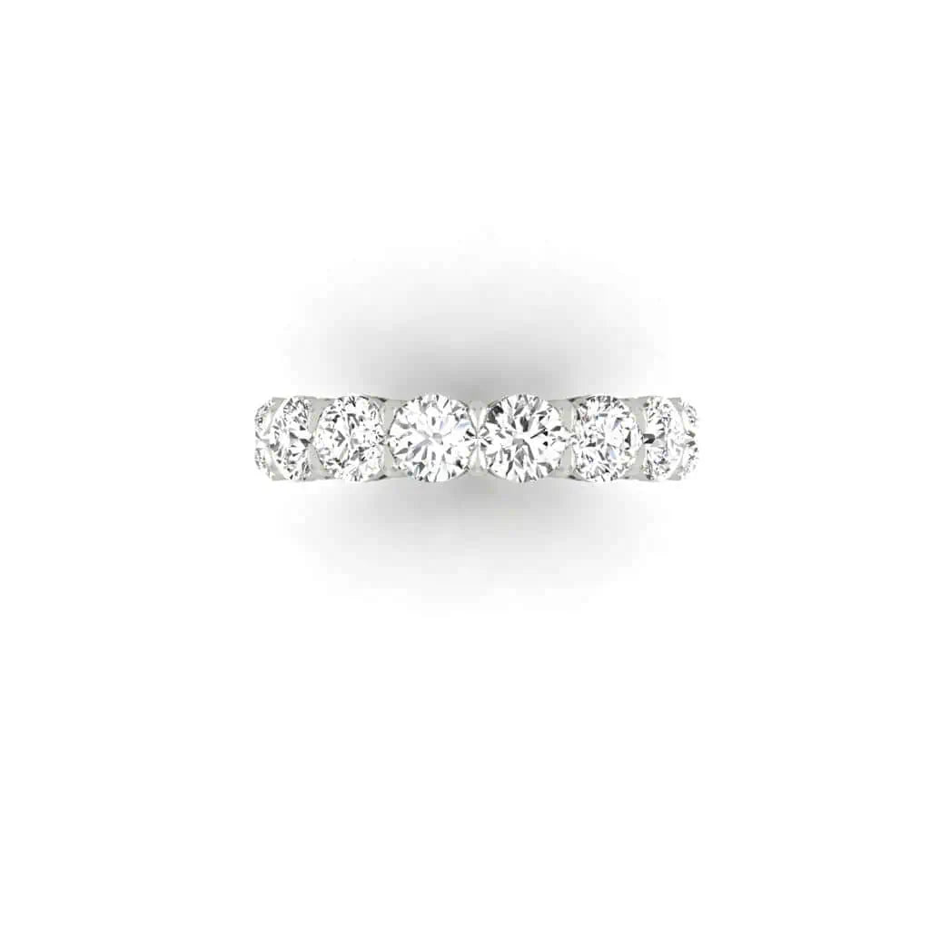 The Full Diamond Eternity Ring from Janet Heller Fine Jewelry, crafted in 18KT gold, features evenly spaced diamonds offered in various shapes and custom carat weights. The color of the diamonds is F and the clarity is VS. This is the perfect wedding band to be worn alone or stacked with your engagement ring.