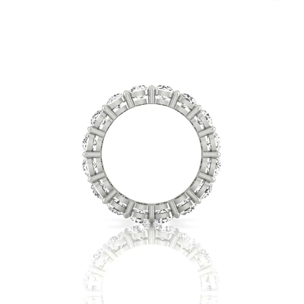 The Full Diamond Eternity Ring from Janet Heller Fine Jewelry, crafted in 18KT gold, features evenly spaced diamonds offered in various shapes and custom carat weights. The color of the diamonds is F and the clarity is VS. This is the perfect wedding band to be worn alone or stacked with your engagement ring.