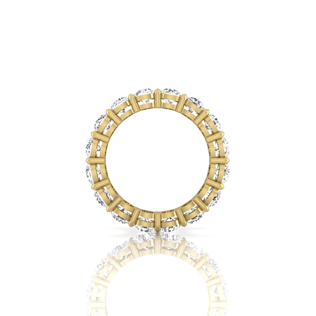 The Full Lab Grown Diamond Eternity Ring, in 18KT gold, showcases a circular design with alternating vertical bars and clusters of white gemstones in F Color VS Clarity. Its reflection is captured at the bottom on a plain white background.