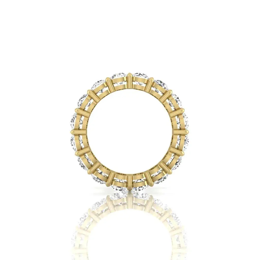The Full Diamond Eternity Ring from Janet Heller Fine Jewelry, crafted in 18KT gold, features evenly spaced diamonds offered in various shapes and custom carat weights. The color of the diamonds is F and the clarity is VS. This is the perfect wedding band to be worn alone or stacked with your engagement ring.
