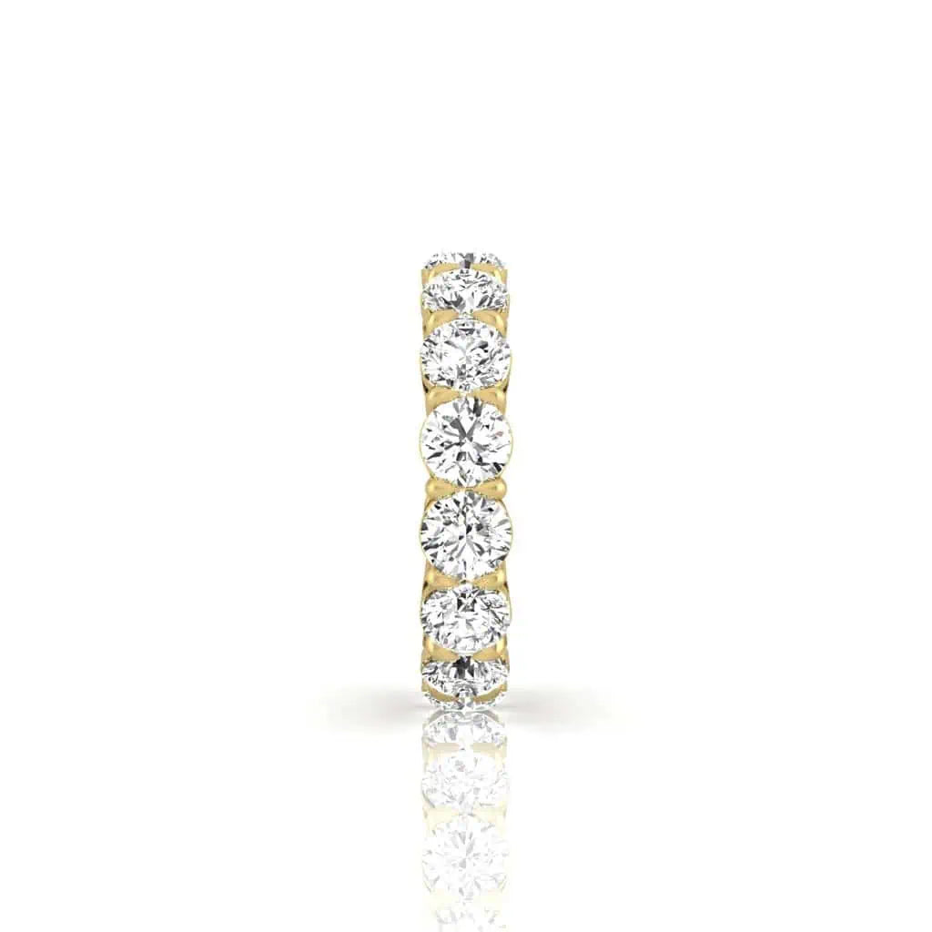 The Full Diamond Eternity Ring from Janet Heller Fine Jewelry, crafted in 18KT gold, features evenly spaced diamonds offered in various shapes and custom carat weights. The color of the diamonds is F and the clarity is VS. This is the perfect wedding band to be worn alone or stacked with your engagement ring.