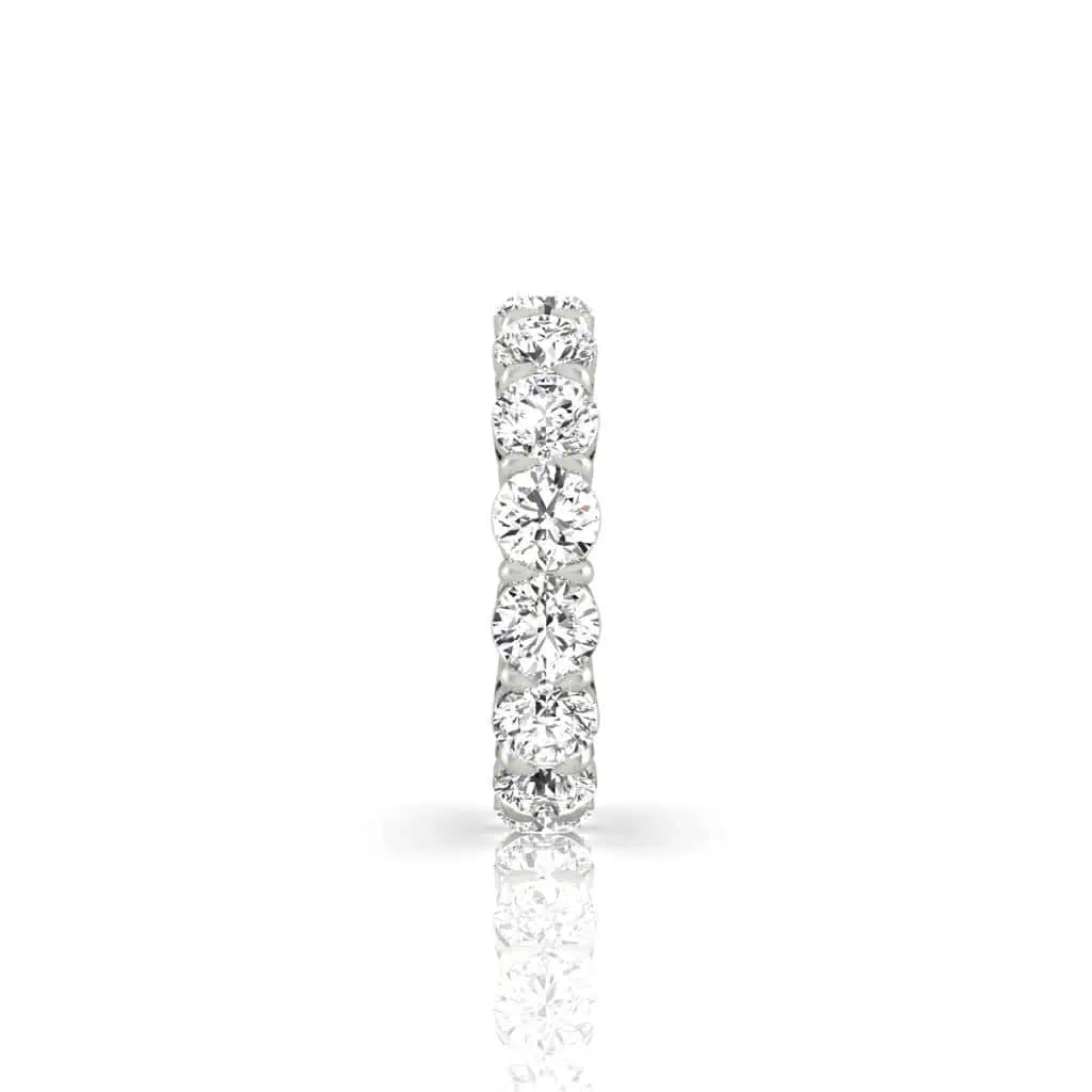 The Full Diamond Eternity Ring from Janet Heller Fine Jewelry, crafted in 18KT gold, features evenly spaced diamonds offered in various shapes and custom carat weights. The color of the diamonds is F and the clarity is VS. This is the perfect wedding band to be worn alone or stacked with your engagement ring.