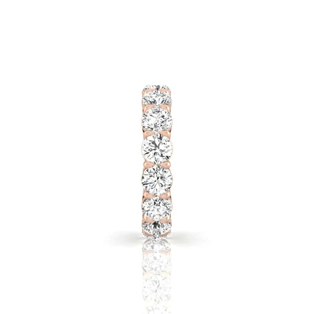 The Full Diamond Eternity Ring from Janet Heller Fine Jewelry, crafted in 18KT gold, features evenly spaced diamonds offered in various shapes and custom carat weights. The color of the diamonds is F and the clarity is VS. This is the perfect wedding band to be worn alone or stacked with your engagement ring.
