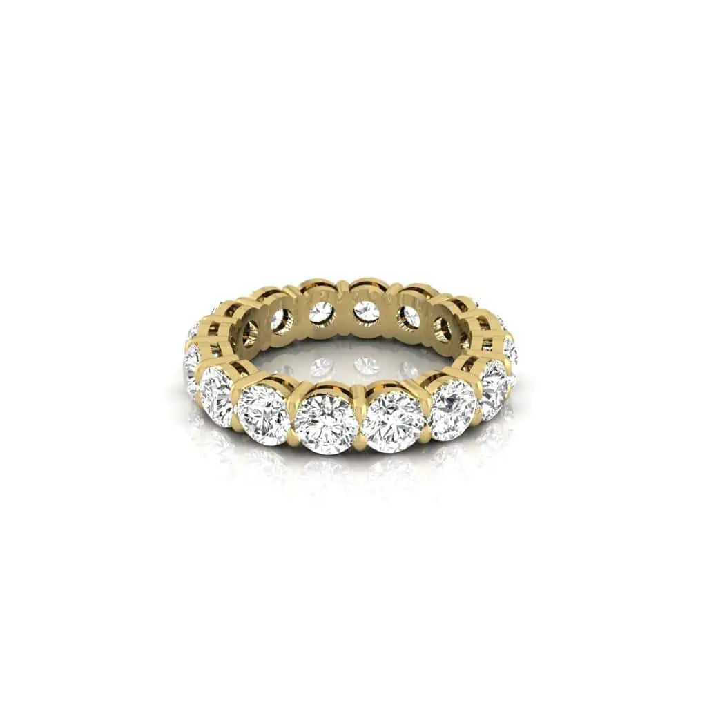 The Full Diamond Eternity Ring from Janet Heller Fine Jewelry, crafted in 18KT gold, features evenly spaced diamonds offered in various shapes and custom carat weights. The color of the diamonds is F and the clarity is VS. This is the perfect wedding band to be worn alone or stacked with your engagement ring.