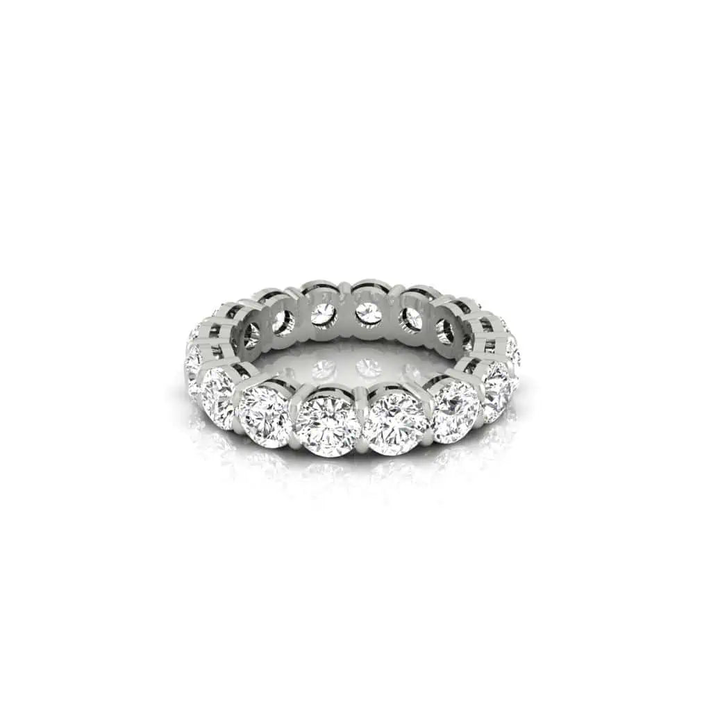 The Full Diamond Eternity Ring from Janet Heller Fine Jewelry, crafted in 18KT gold, features evenly spaced diamonds offered in various shapes and custom carat weights. The color of the diamonds is F and the clarity is VS. This is the perfect wedding band to be worn alone or stacked with your engagement ring.