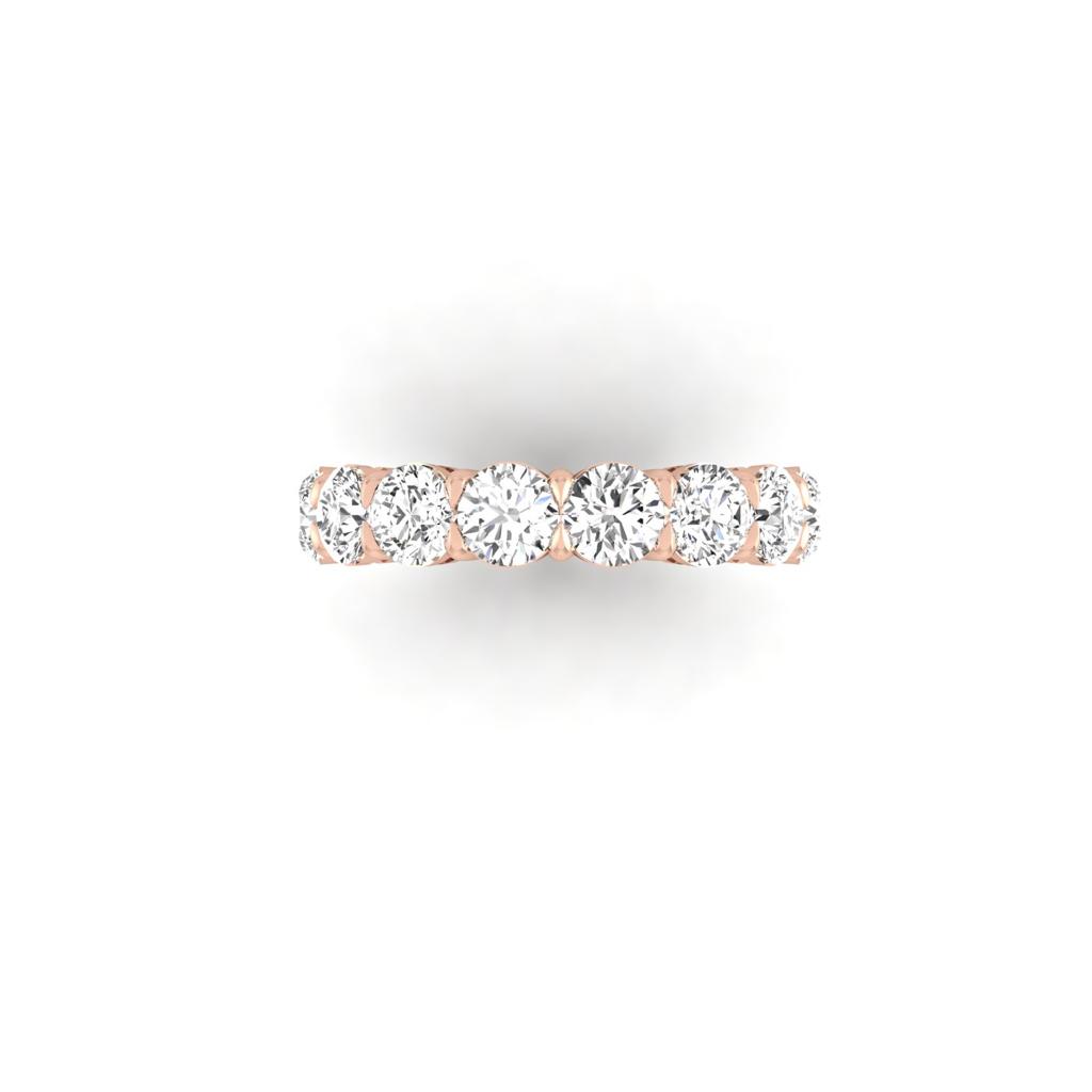 The Full Lab Grown Diamond Eternity Ring is crafted in 18KT gold, showcasing a row of seven evenly spaced round-cut diamonds with F Color VS Clarity, set along its band on a plain white backdrop.