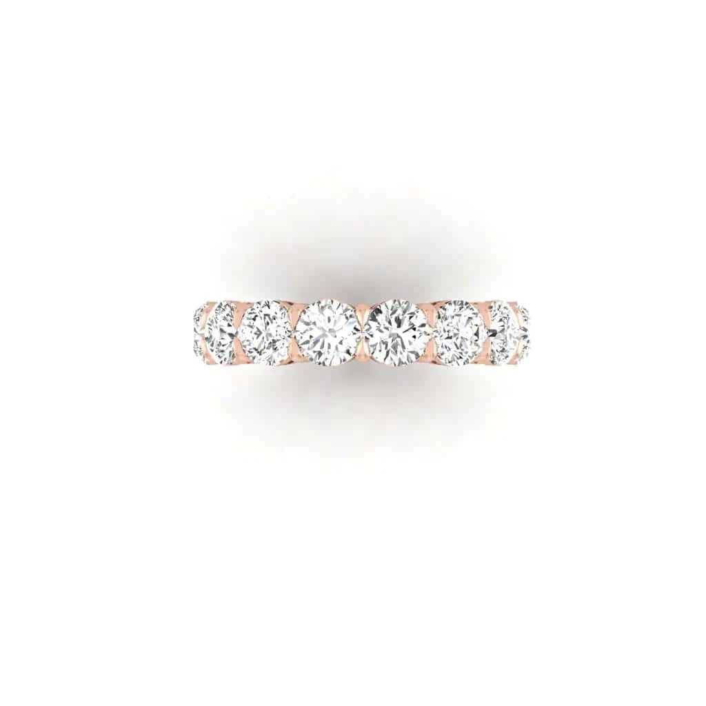The Full Diamond Eternity Ring from Janet Heller Fine Jewelry, crafted in 18KT gold, features evenly spaced diamonds offered in various shapes and custom carat weights. The color of the diamonds is F and the clarity is VS. This is the perfect wedding band to be worn alone or stacked with your engagement ring.