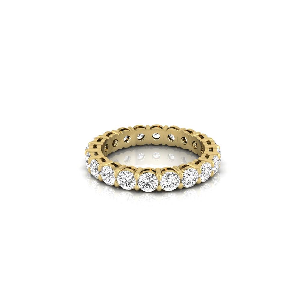 The Full Lab Grown Diamond Eternity Ring is an 18KT gold piece showcasing round, white diamonds with F color and VS clarity, displayed on a reflective surface.