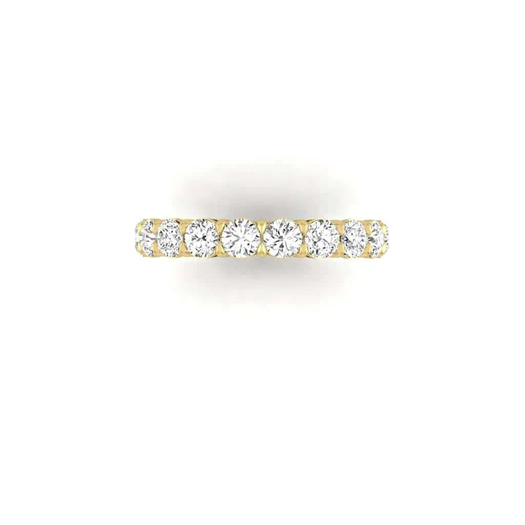 The Full Diamond Eternity Ring from Janet Heller Fine Jewelry, crafted in 18KT gold, features evenly spaced diamonds offered in various shapes and custom carat weights. The color of the diamonds is F and the clarity is VS. This is the perfect wedding band to be worn alone or stacked with your engagement ring.