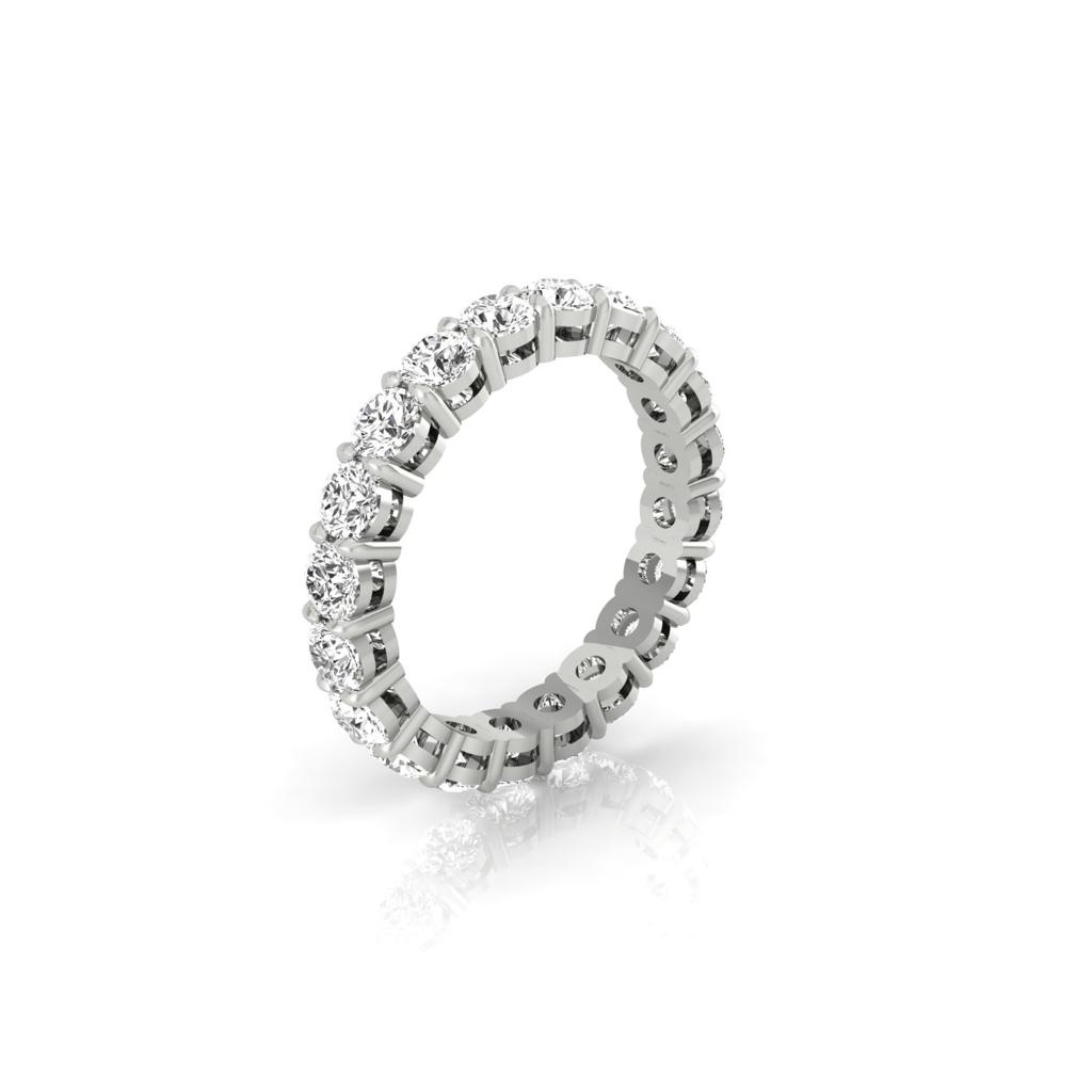 The Full Lab Grown Diamond Eternity Ring, crafted in stunning 18KT gold, features numerous round-cut diamonds with F Color and VS Clarity. Glistening vertically against a pristine white background, this silver ring captures dazzling brilliance in its design.