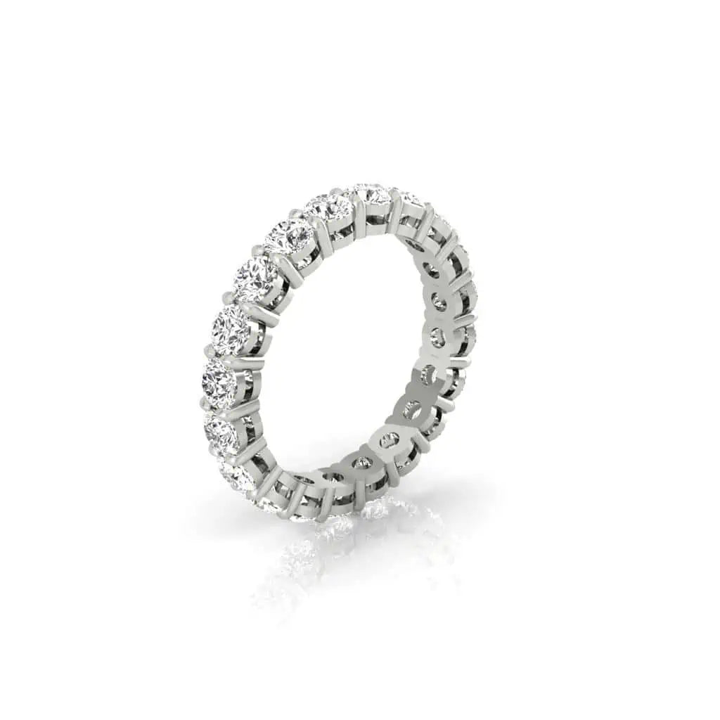 The Full Diamond Eternity Ring from Janet Heller Fine Jewelry, crafted in 18KT gold, features evenly spaced diamonds offered in various shapes and custom carat weights. The color of the diamonds is F and the clarity is VS. This is the perfect wedding band to be worn alone or stacked with your engagement ring.