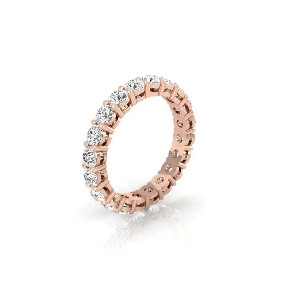 The Full Diamond Eternity Ring from Janet Heller Fine Jewelry, crafted in 18KT gold, features evenly spaced diamonds offered in various shapes and custom carat weights. The color of the diamonds is F and the clarity is VS. This is the perfect wedding band to be worn alone or stacked with your engagement ring.