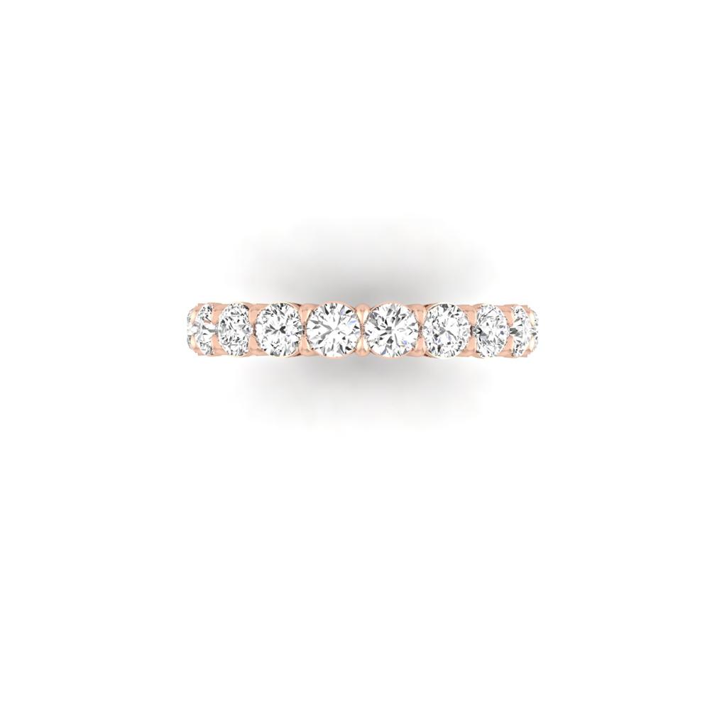 The Full Lab Grown Diamond Eternity Ring showcases a continuous row of round diamonds in 18KT gold, featuring F Color VS Clarity. The elegant band is presented from above on a white background.