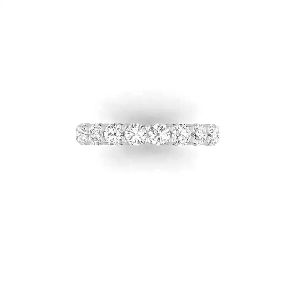 The Full Diamond Eternity Ring from Janet Heller Fine Jewelry, crafted in 18KT gold, features evenly spaced diamonds offered in various shapes and custom carat weights. The color of the diamonds is F and the clarity is VS. This is the perfect wedding band to be worn alone or stacked with your engagement ring.