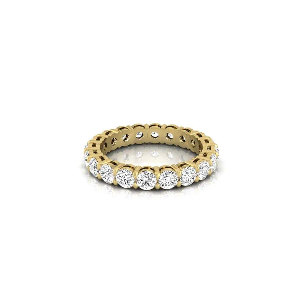 The Full Diamond Eternity Ring from Janet Heller Fine Jewelry, crafted in 18KT gold, features evenly spaced diamonds offered in various shapes and custom carat weights. The color of the diamonds is F and the clarity is VS. This is the perfect wedding band to be worn alone or stacked with your engagement ring.