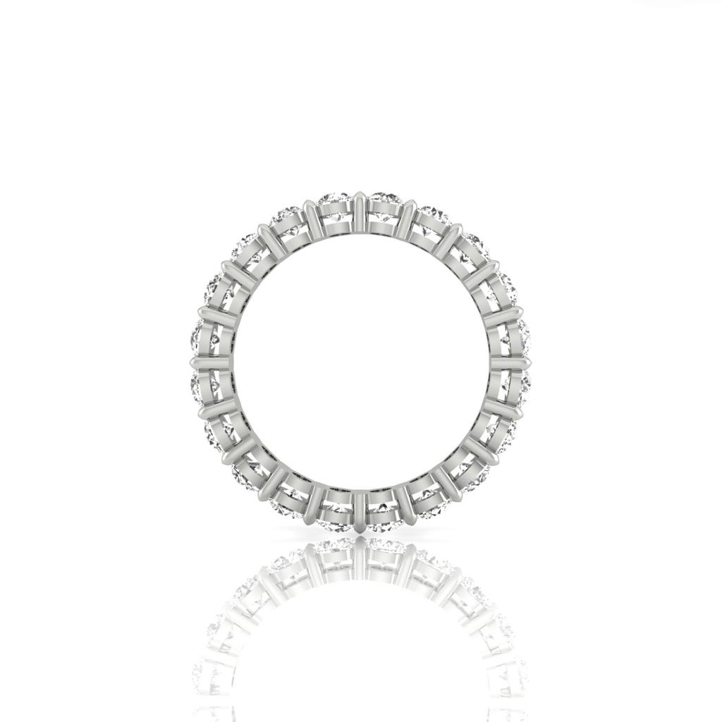 The Full Lab Grown Diamond Eternity Ring, crafted in gleaming 18KT gold, features a circular array of F Color VS Clarity gemstones. Its showcased vertically on a smooth white surface, highlighting its stunning beauty.