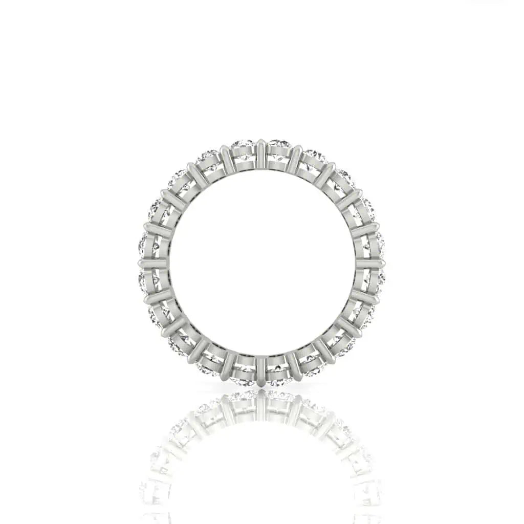 The Full Diamond Eternity Ring from Janet Heller Fine Jewelry, crafted in 18KT gold, features evenly spaced diamonds offered in various shapes and custom carat weights. The color of the diamonds is F and the clarity is VS. This is the perfect wedding band to be worn alone or stacked with your engagement ring.