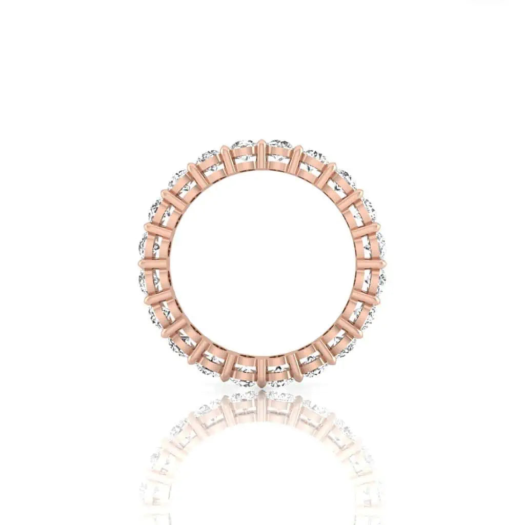 The Full Diamond Eternity Ring from Janet Heller Fine Jewelry, crafted in 18KT gold, features evenly spaced diamonds offered in various shapes and custom carat weights. The color of the diamonds is F and the clarity is VS. This is the perfect wedding band to be worn alone or stacked with your engagement ring.