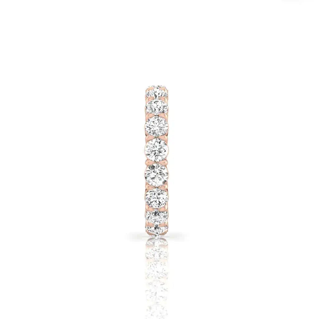 The Full Diamond Eternity Ring from Janet Heller Fine Jewelry, crafted in 18KT gold, features evenly spaced diamonds offered in various shapes and custom carat weights. The color of the diamonds is F and the clarity is VS. This is the perfect wedding band to be worn alone or stacked with your engagement ring.