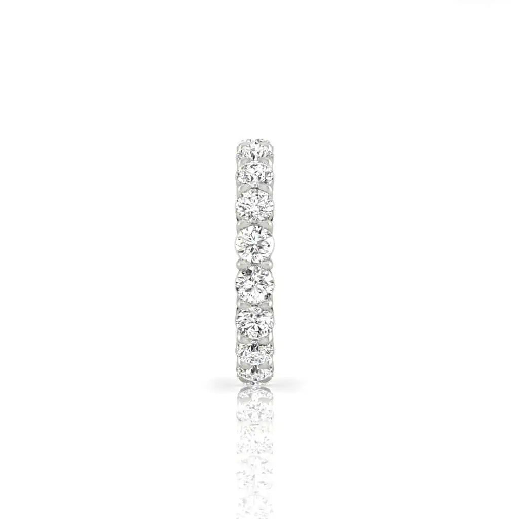 The Full Diamond Eternity Ring from Janet Heller Fine Jewelry, crafted in 18KT gold, features evenly spaced diamonds offered in various shapes and custom carat weights. The color of the diamonds is F and the clarity is VS. This is the perfect wedding band to be worn alone or stacked with your engagement ring.