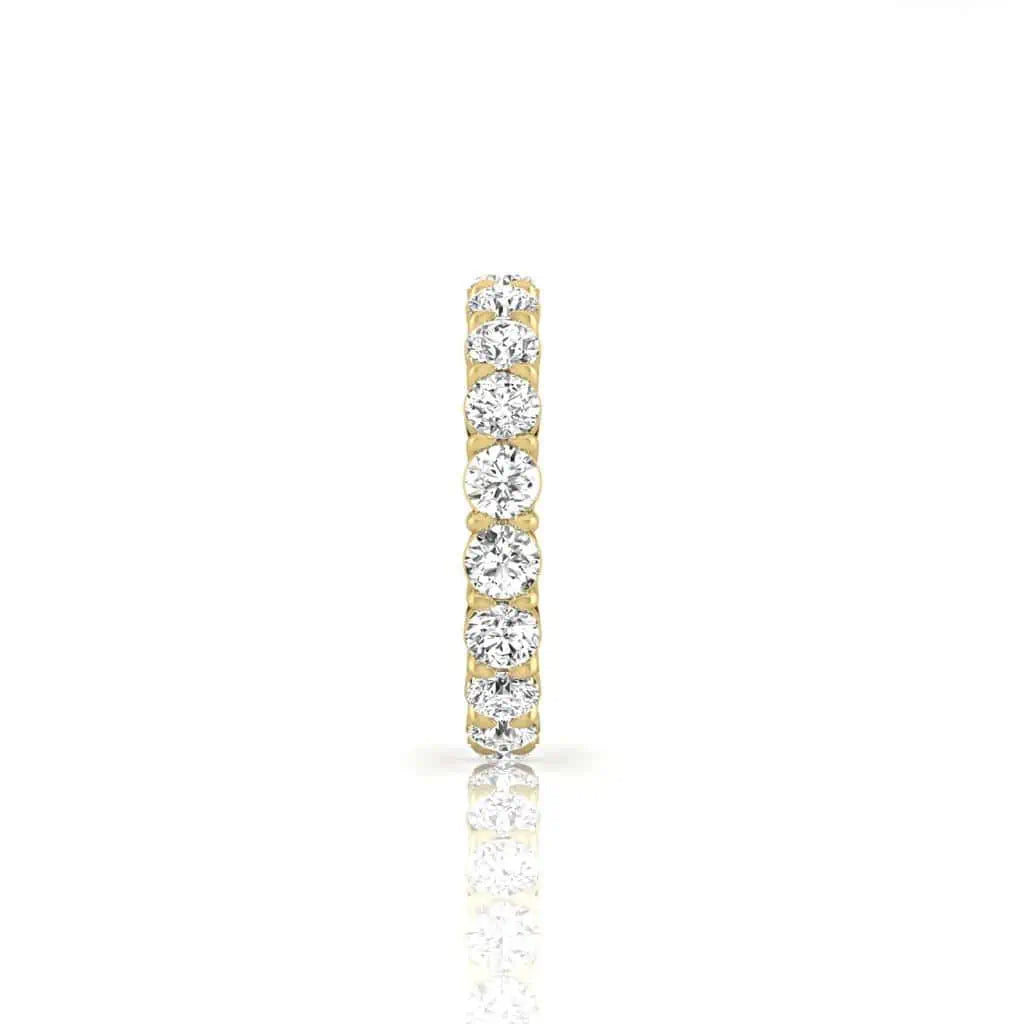 The Full Diamond Eternity Ring from Janet Heller Fine Jewelry, crafted in 18KT gold, features evenly spaced diamonds offered in various shapes and custom carat weights. The color of the diamonds is F and the clarity is VS. This is the perfect wedding band to be worn alone or stacked with your engagement ring.