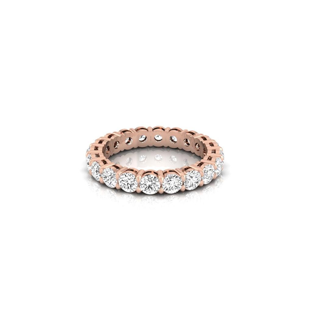 The Full Lab Grown Diamond Eternity Ring is an 18KT rose gold band with F Color VS Clarity diamonds encircling the entire ring, reflecting light beautifully against a white backdrop.