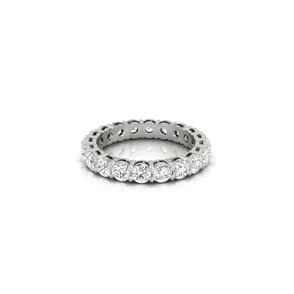 The Full Lab Grown Diamond Eternity Ring features a silver band with F Color VS Clarity round-cut diamonds in a prong setting, creating a brilliant circle that reflects light from its polished surface.