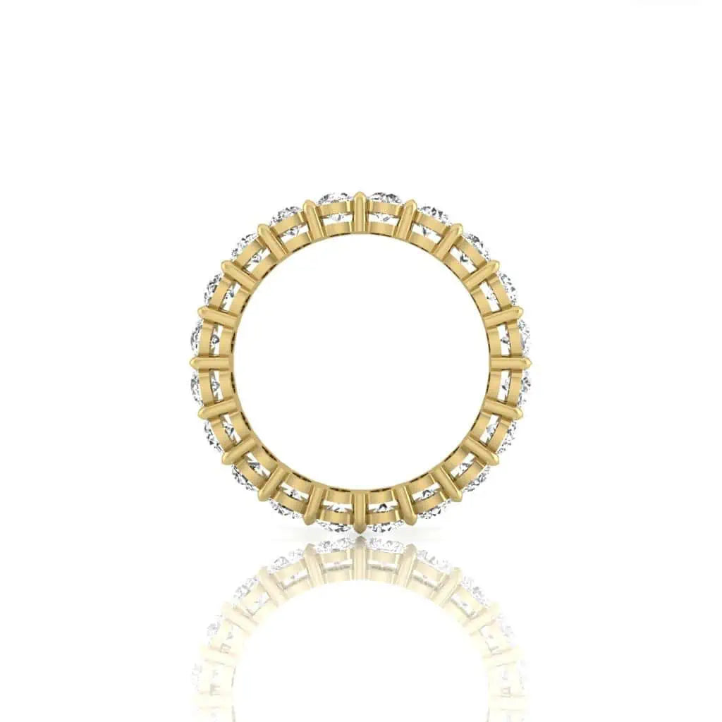 The Full Diamond Eternity Ring from Janet Heller Fine Jewelry, crafted in 18KT gold, features evenly spaced diamonds offered in various shapes and custom carat weights. The color of the diamonds is F and the clarity is VS. This is the perfect wedding band to be worn alone or stacked with your engagement ring.