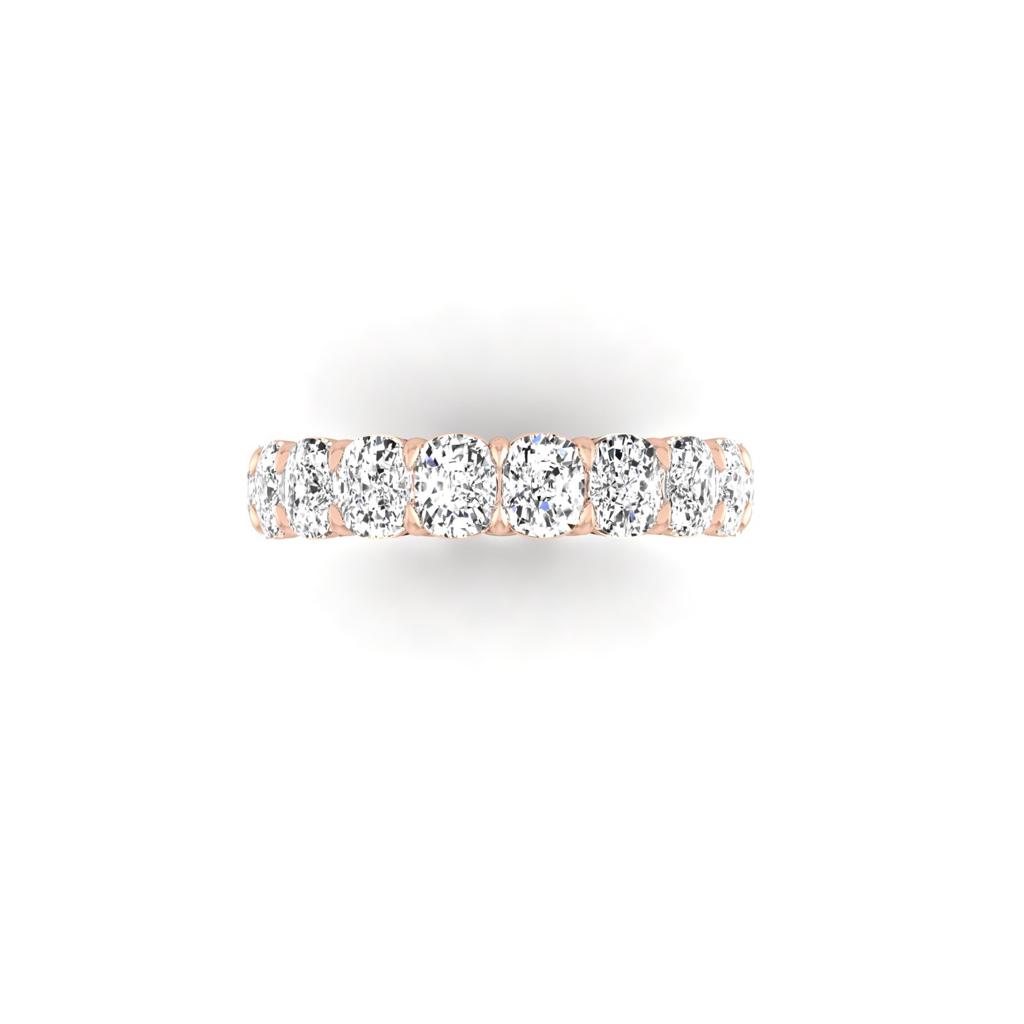 The Full Lab Grown Diamond Eternity Ring from Janet Heller Fine Jewelry, crafted in 18KT gold, features evenly spaced diamonds offered in various shapes and custom carat weights. The color of the diamonds is F and the clarity is VS. This is the perfect wedding band to be worn alone or stacked with your engagement ring.
