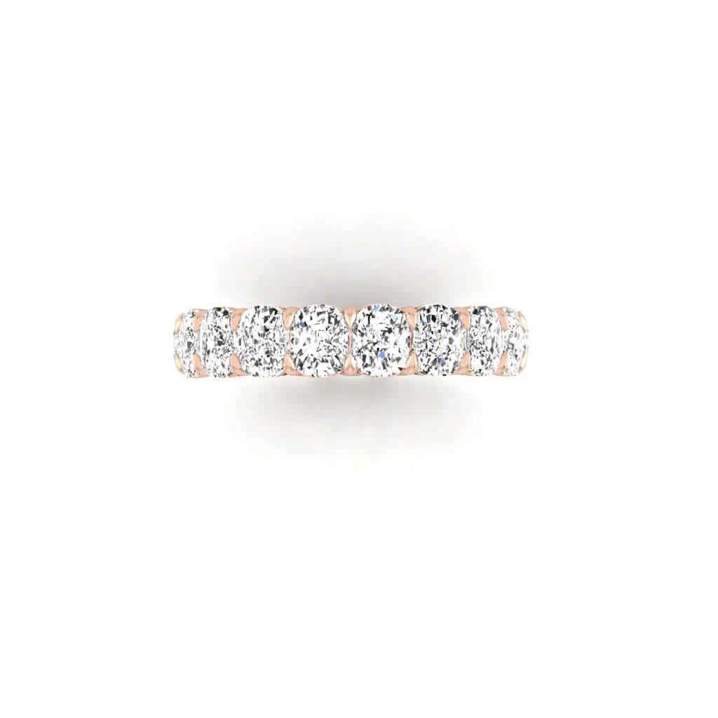 The Full Diamond Eternity Ring is a sophisticated 18KT gold band featuring a row of shimmering F Color, VS Clarity diamonds, elegantly displayed on a crisp white background.