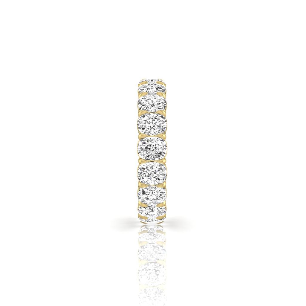 The Full Lab Grown Diamond Eternity Ring from Janet Heller Fine Jewelry, crafted in 18KT gold, features evenly spaced diamonds offered in various shapes and custom carat weights. The color of the diamonds is F and the clarity is VS. This is the perfect wedding band to be worn alone or stacked with your engagement ring.