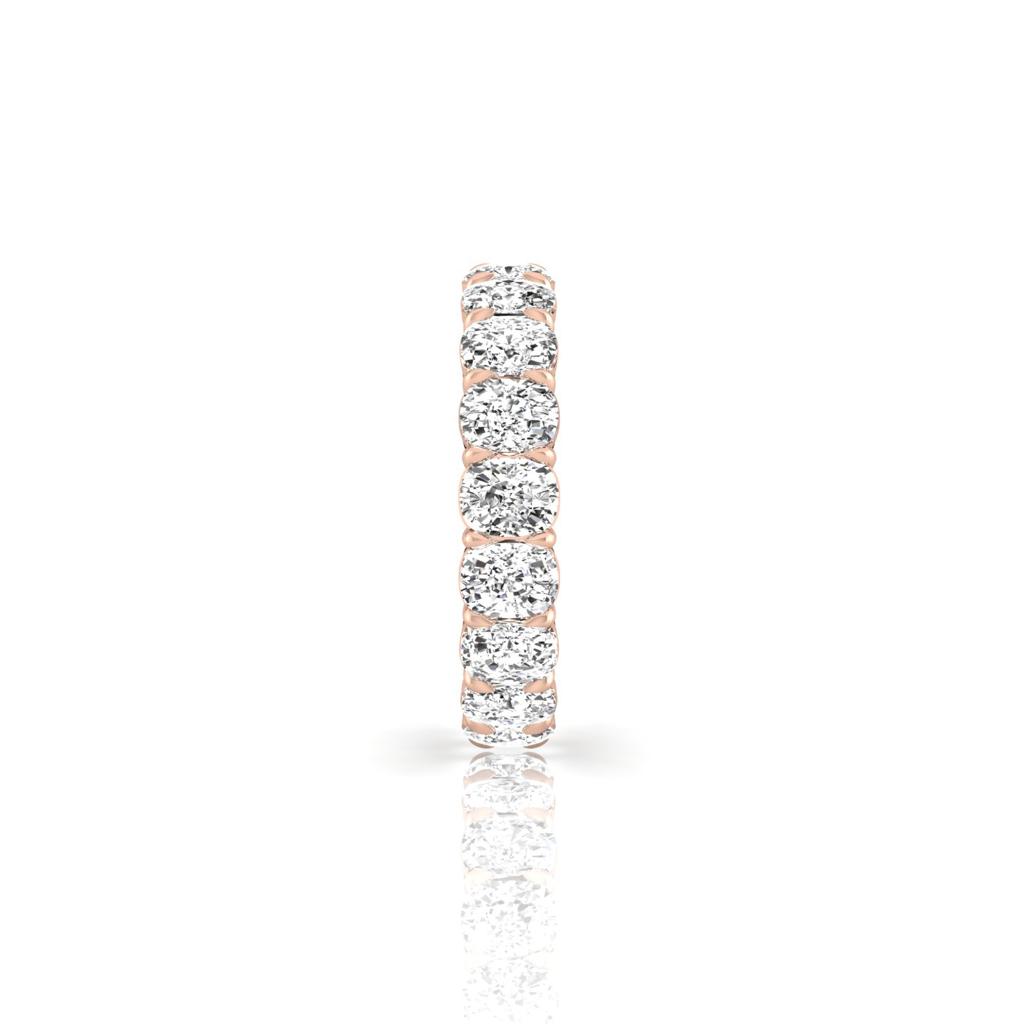 The Full Lab Grown Diamond Eternity Ring from Janet Heller Fine Jewelry, crafted in 18KT gold, features evenly spaced diamonds offered in various shapes and custom carat weights. The color of the diamonds is F and the clarity is VS. This is the perfect wedding band to be worn alone or stacked with your engagement ring.