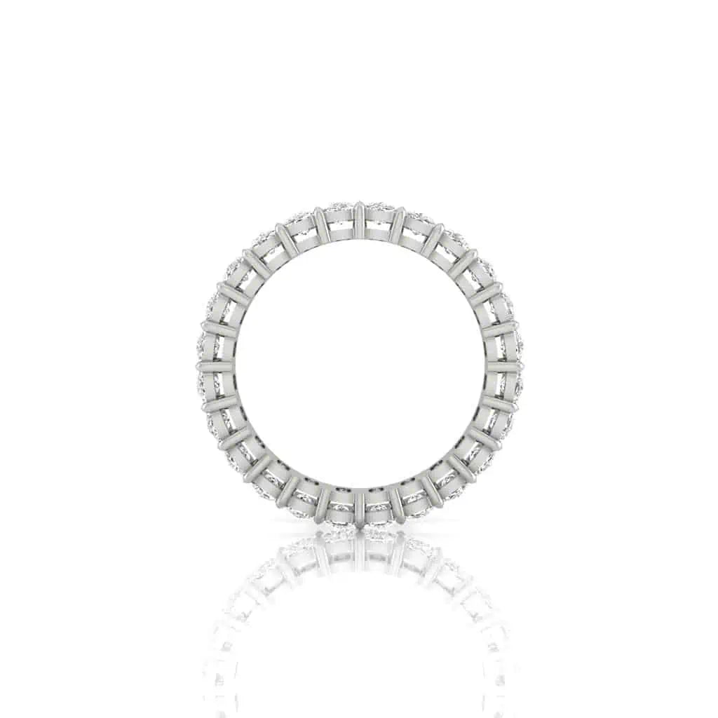 The Full Diamond Eternity Ring, made of 18KT radiant gold, showcases closely set F color, VS clarity emerald-cut diamonds in a continuous loop. Displayed on a white background, it highlights its intricate detailing and reflective surface.