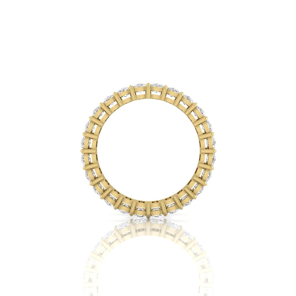 The Full Lab Grown Diamond Eternity Ring from Janet Heller Fine Jewelry, crafted in 18KT gold, features evenly spaced diamonds offered in various shapes and custom carat weights. The color of the diamonds is F and the clarity is VS. This is the perfect wedding band to be worn alone or stacked with your engagement ring.