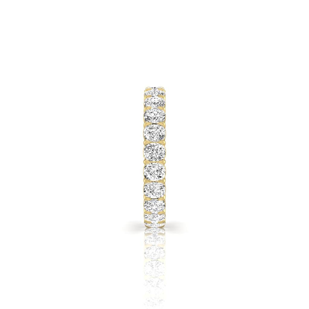 The Full Lab Grown Diamond Eternity Ring from Janet Heller Fine Jewelry, crafted in 18KT gold, features evenly spaced diamonds offered in various shapes and custom carat weights. The color of the diamonds is F and the clarity is VS. This is the perfect wedding band to be worn alone or stacked with your engagement ring.