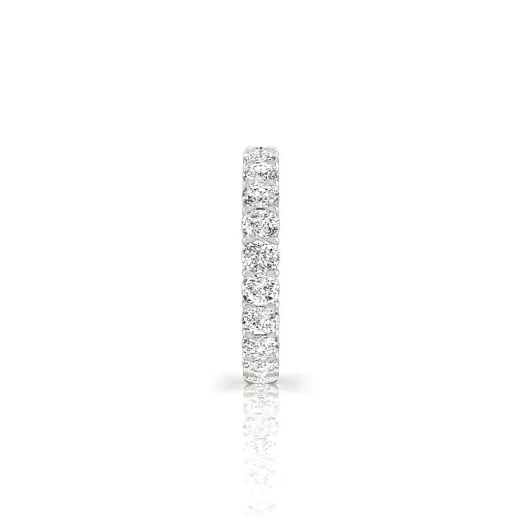 A close-up of the Full Diamond Eternity Ring, featuring VS Clarity, F Color diamonds in shimmering silver. The side view against a plain white background emphasizes its exquisite, sparkling gemstones.