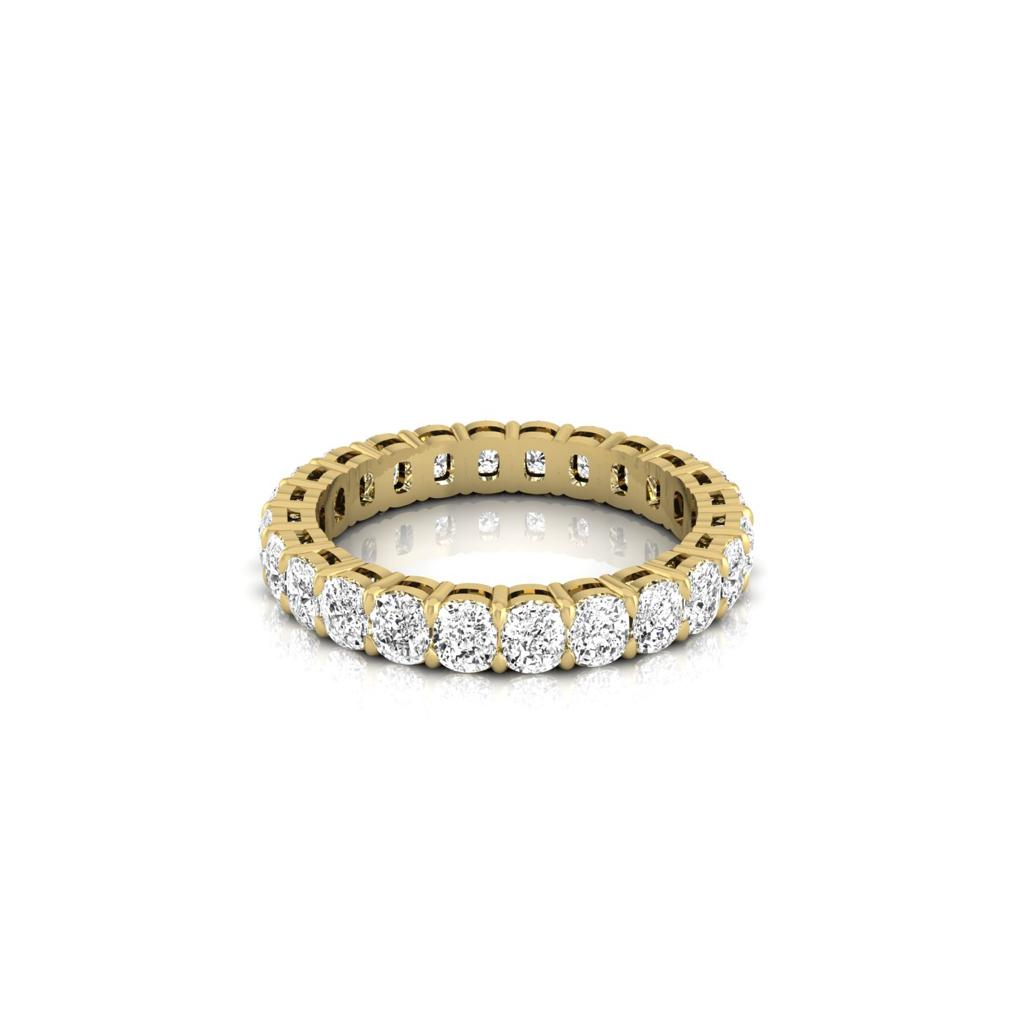The Full Lab Grown Diamond Eternity Ring from Janet Heller Fine Jewelry, crafted in 18KT gold, features evenly spaced diamonds offered in various shapes and custom carat weights. The color of the diamonds is F and the clarity is VS. This is the perfect wedding band to be worn alone or stacked with your engagement ring.