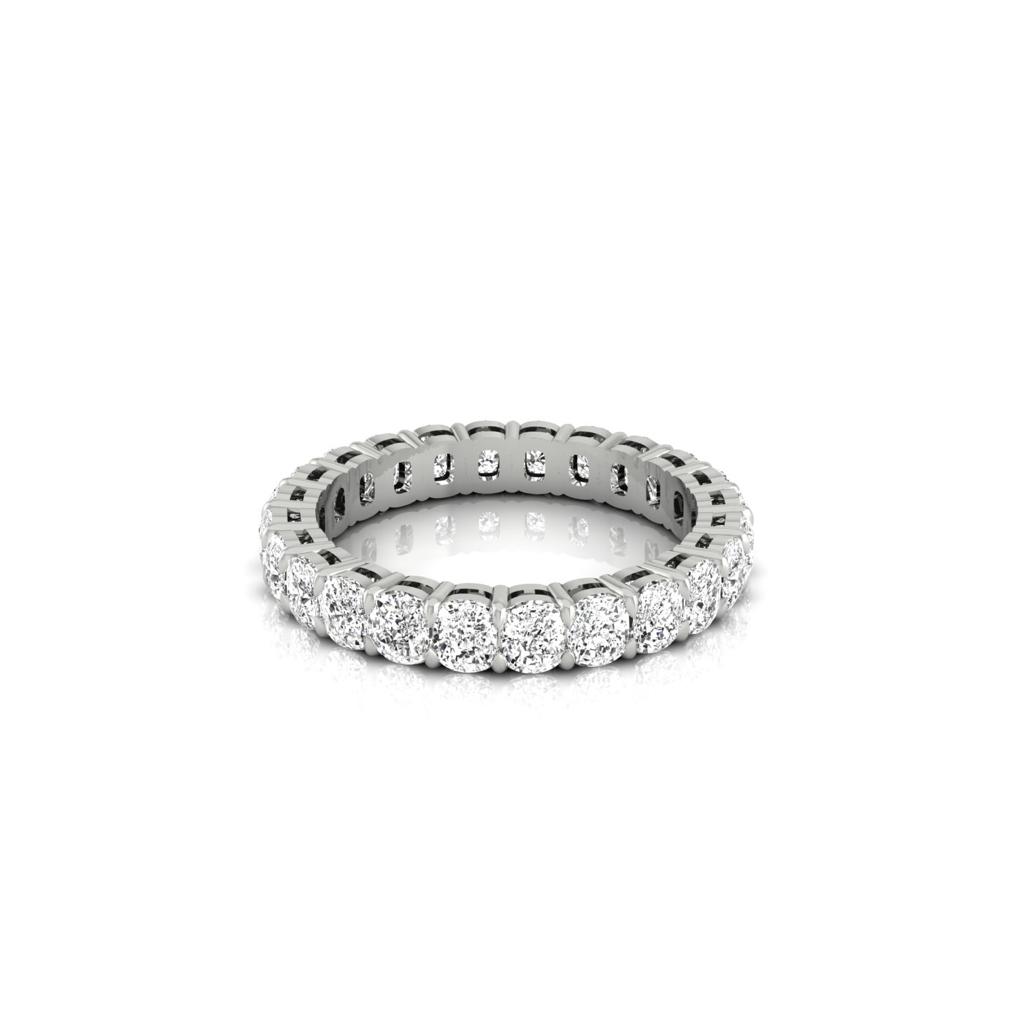 The Full Lab Grown Diamond Eternity Ring dazzles with a seamless loop of round diamonds, F color, VS clarity, set in an intricately crafted silver band that enhances their shine and exudes the sophisticated elegance reminiscent of 18KT gold.