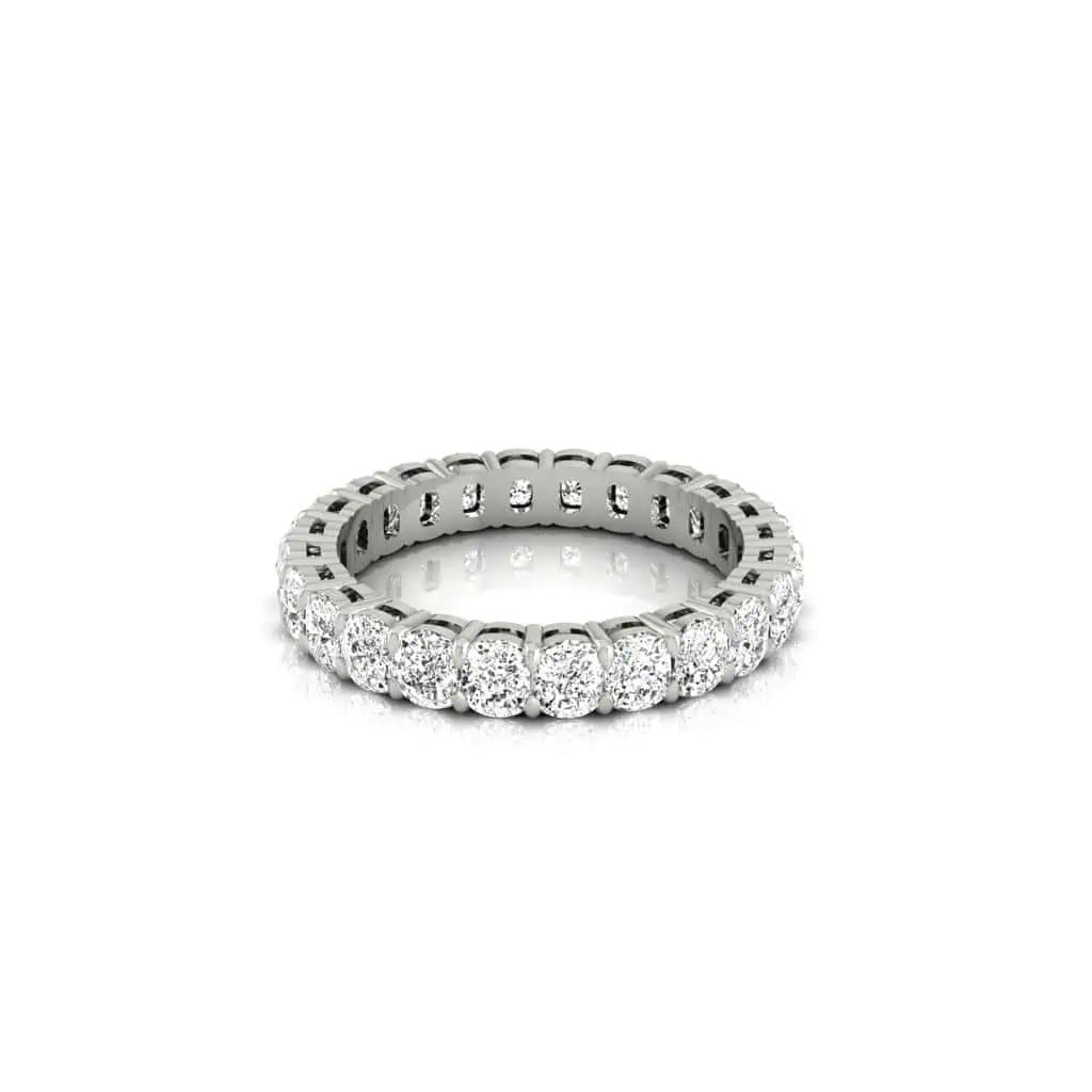The Full Diamond Eternity Ring features a circle of round, sparkling F Color diamonds with VS Clarity in a claw setting against a white backdrop, symbolizing eternal love and commitment.