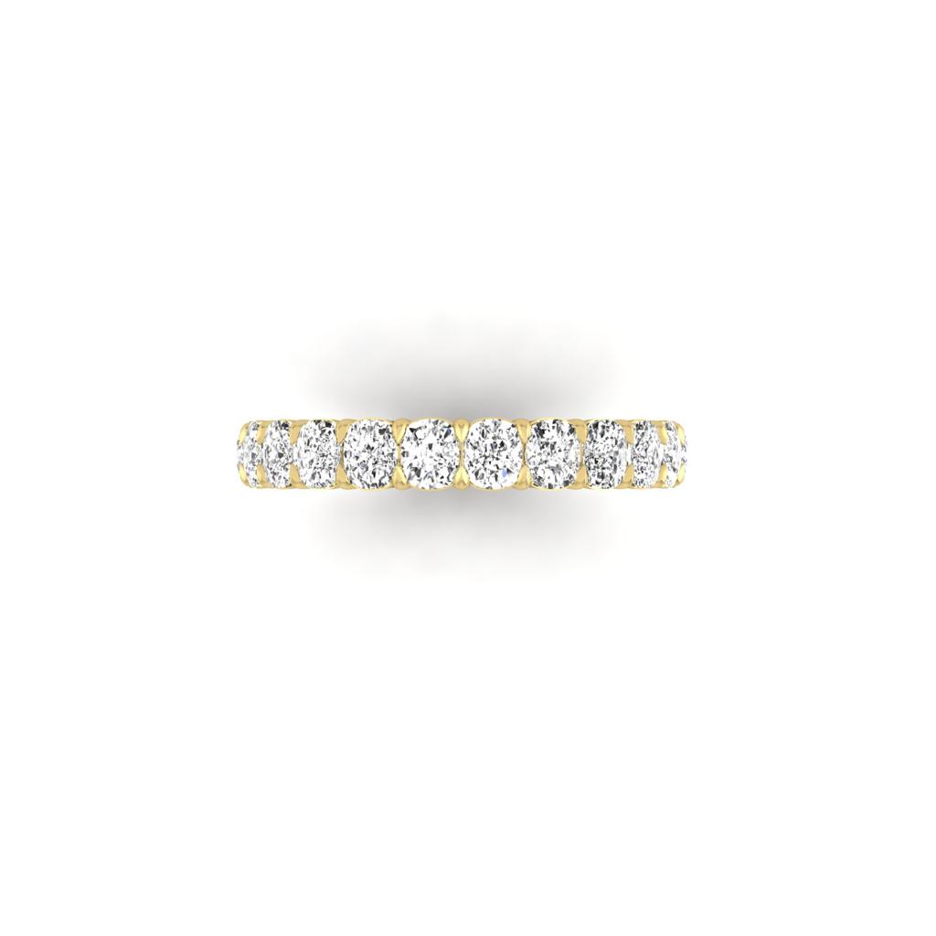The Full Lab Grown Diamond Eternity Ring from Janet Heller Fine Jewelry, crafted in 18KT gold, features evenly spaced diamonds offered in various shapes and custom carat weights. The color of the diamonds is F and the clarity is VS. This is the perfect wedding band to be worn alone or stacked with your engagement ring.