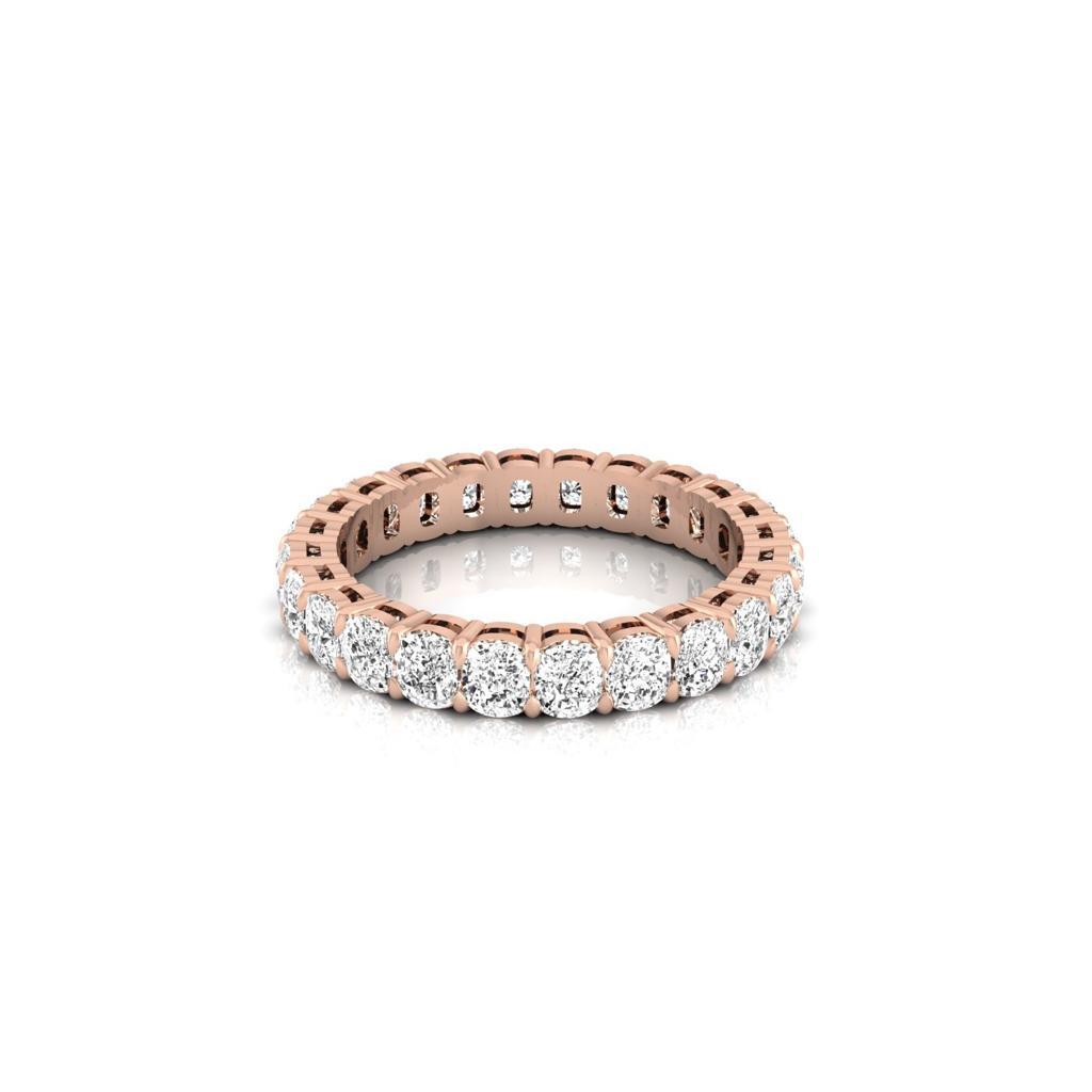 The Full Lab Grown Diamond Eternity Ring from Janet Heller Fine Jewelry, crafted in 18KT gold, features evenly spaced diamonds offered in various shapes and custom carat weights. The color of the diamonds is F and the clarity is VS. This is the perfect wedding band to be worn alone or stacked with your engagement ring.