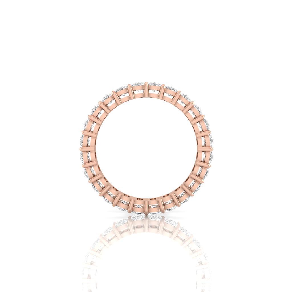 The Full Lab Grown Diamond Eternity Ring from Janet Heller Fine Jewelry, crafted in 18KT gold, features evenly spaced diamonds offered in various shapes and custom carat weights. The color of the diamonds is F and the clarity is VS. This is the perfect wedding band to be worn alone or stacked with your engagement ring.