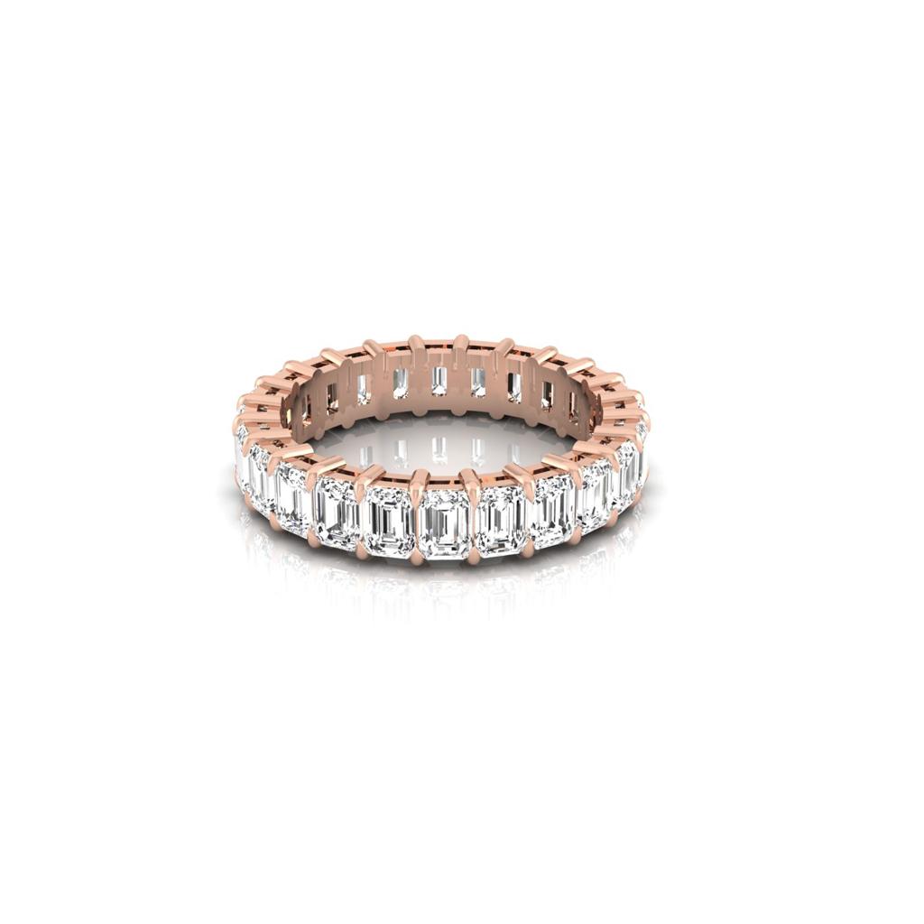 The Full Lab Grown Diamond Eternity Ring from Janet Heller Fine Jewelry, crafted in 18KT gold, features evenly spaced diamonds offered in various shapes and custom carat weights. The color of the diamonds is F and the clarity is VS. This is the perfect wedding band to be worn alone or stacked with your engagement ring.