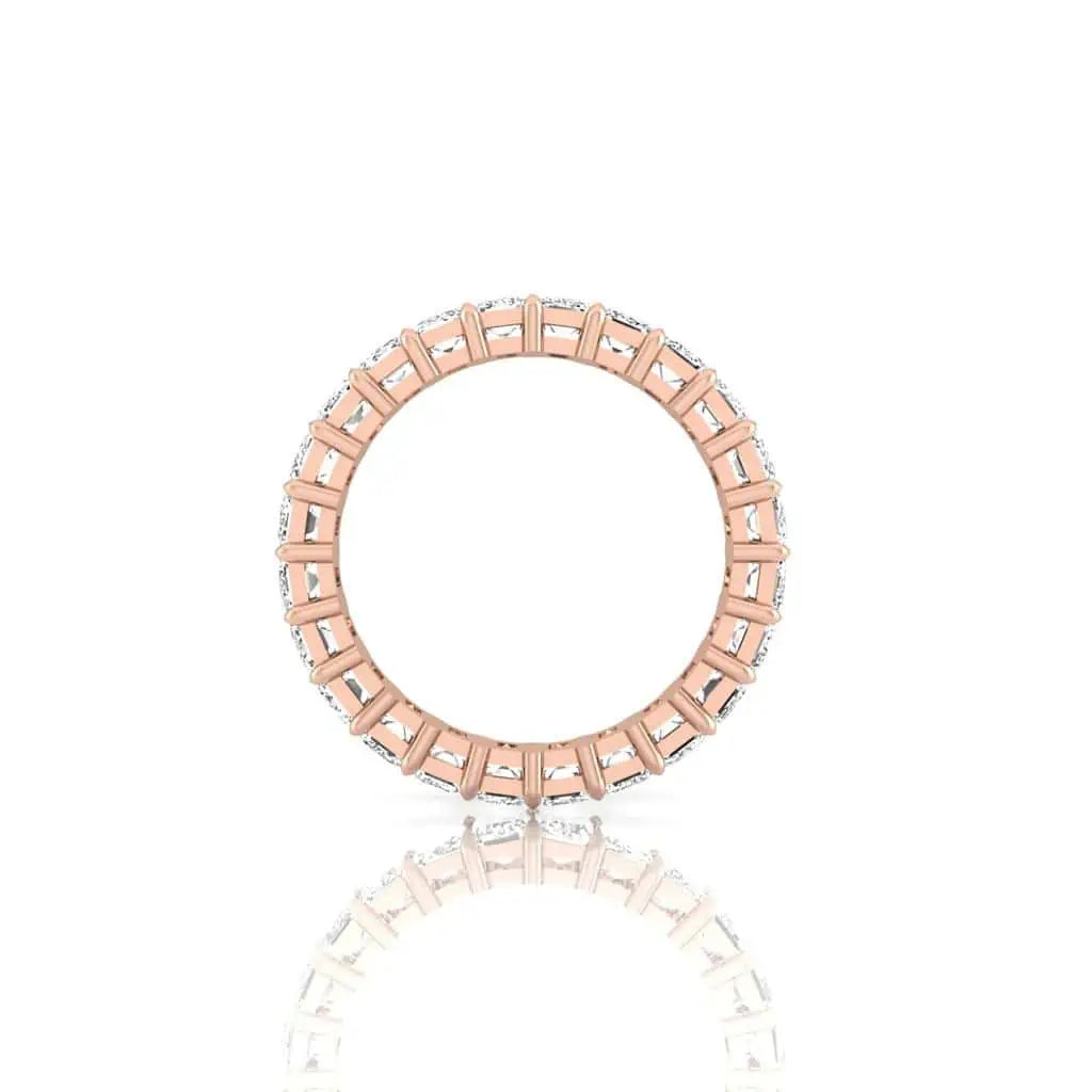 The Full Diamond Eternity Ring from Janet Heller Fine Jewelry, crafted in 18KT gold, features evenly spaced diamonds offered in various shapes and custom carat weights. The color of the diamonds is F and the clarity is VS. This is the perfect wedding band to be worn alone or stacked with your engagement ring.