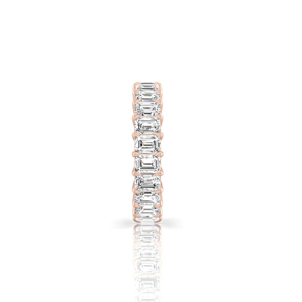 The Full Lab Grown Diamond Eternity Ring from Janet Heller Fine Jewelry, crafted in 18KT gold, features evenly spaced diamonds offered in various shapes and custom carat weights. The color of the diamonds is F and the clarity is VS. This is the perfect wedding band to be worn alone or stacked with your engagement ring.