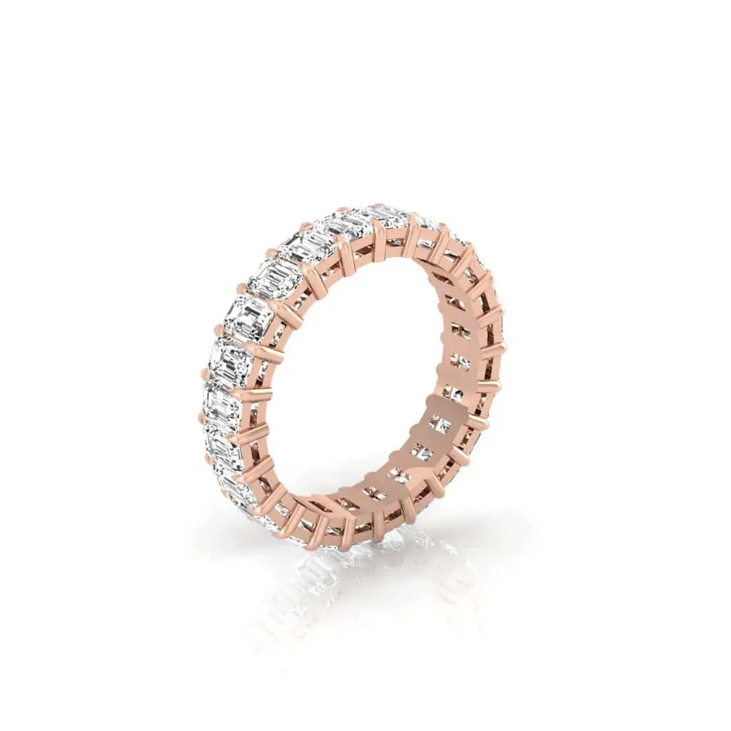 The Full Diamond Eternity Ring from Janet Heller Fine Jewelry, crafted in 18KT gold, features evenly spaced diamonds offered in various shapes and custom carat weights. The color of the diamonds is F and the clarity is VS. This is the perfect wedding band to be worn alone or stacked with your engagement ring.