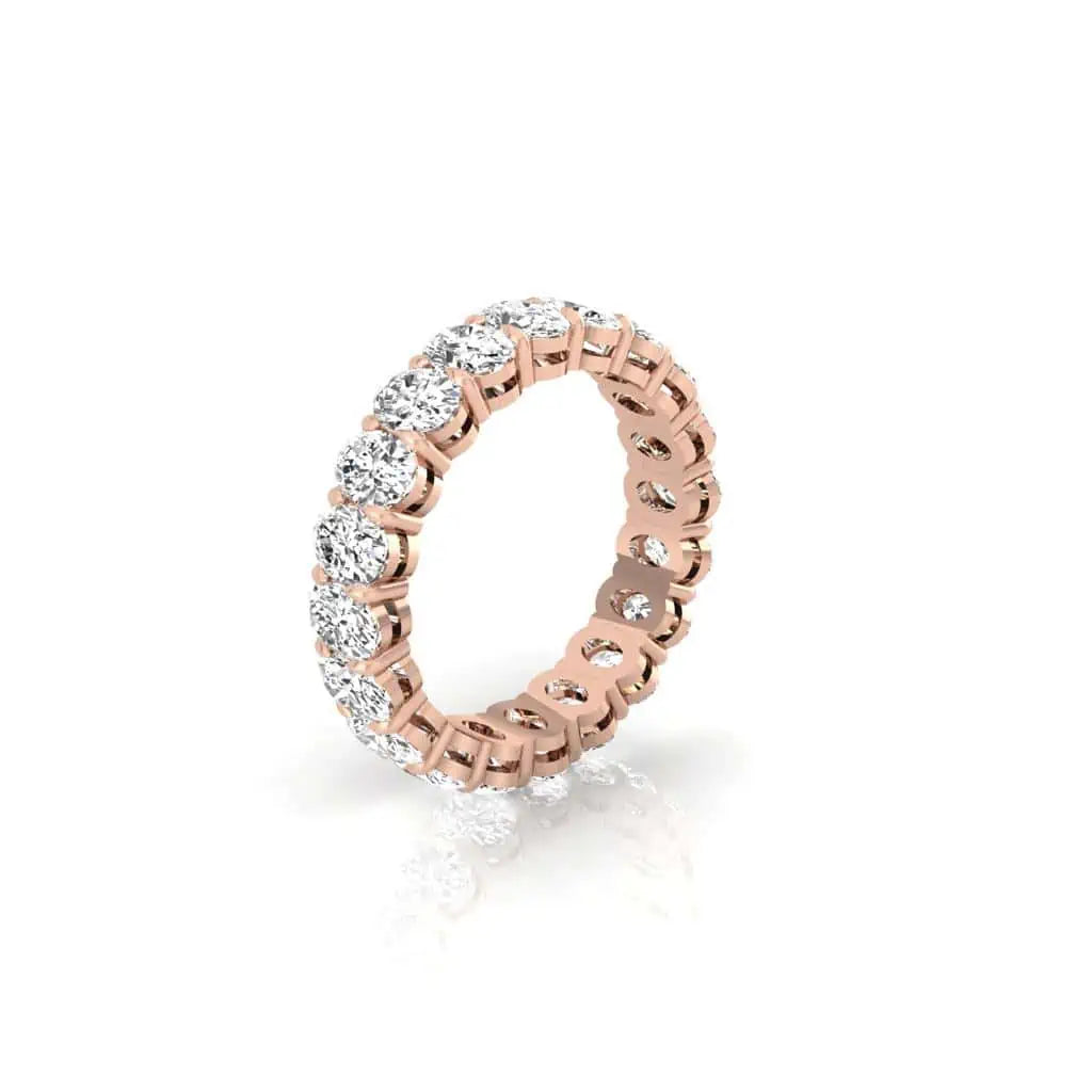 The Full Diamond Eternity Ring from Janet Heller Fine Jewelry, crafted in 18KT gold, features evenly spaced diamonds offered in various shapes and custom carat weights. The color of the diamonds is F and the clarity is VS. This is the perfect wedding band to be worn alone or stacked with your engagement ring.